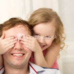 Daughter playing with father closing his eyes