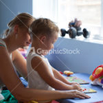 Mother playing learning game with son