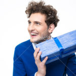 Happy man holding gift over white background
