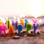 Birthday candles burning on a seashore