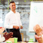 Cheerful business people applauding in a meeting. Business concept.