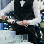 Waiter pouring glasses of champagne