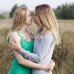 Two sisters or female friends in a close embrace