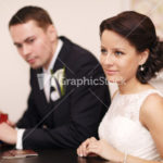 Couple at a reception desk with their passports
