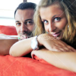 happy couple relax on red sofa