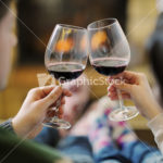 Young romantic couple sitting on sofa in front of fireplace at h