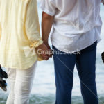 Couple holding hands at the seaside