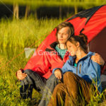 Camping couple enjoying sunset