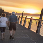 older couple walking at sunset